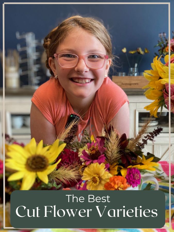 Girl with cut flower bouquets made from zinnias, basil, and sunflowers